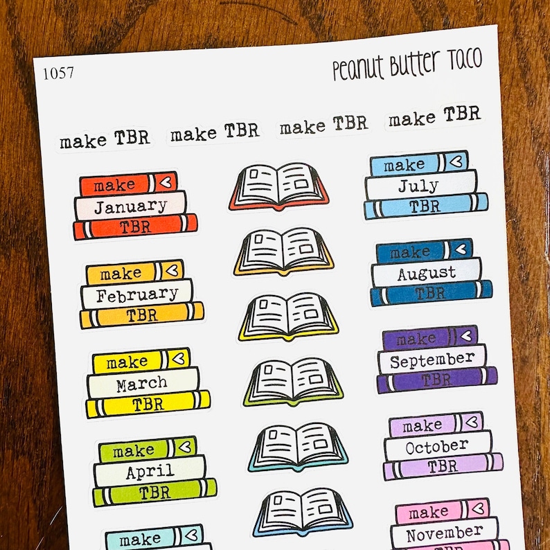 May include: A sheet of stickers with a book stack design for each month of the year. The stickers are colorful and feature the text "make TBR" and the month of the year. The text "Peanut Butter Taco" is at the top of the sheet.