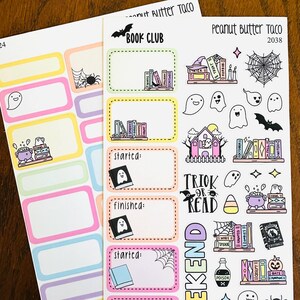May include: Two sheets of colorful planner stickers with a Halloween theme. Designs include ghosts, bats, spiderwebs, books, and the words "Book Club", "Trick or Read", and "Weekend". The stickers have a variety of shapes and sizes.