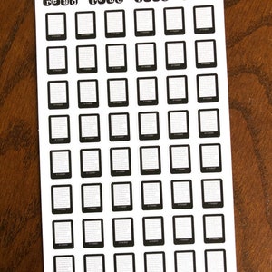 May include: A sheet of black and white planner stickers with the word "read" printed on each sticker. The stickers are in the shape of a book and are arranged in a grid pattern. The sheet is labeled "Peanut Butter Taco".