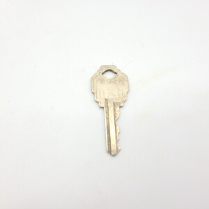 May include: A silver key with the word "President" engraved on the top.