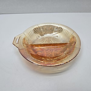 May include: A divided glass serving dish with a handle. The dish is made of amber glass with a swirl pattern.