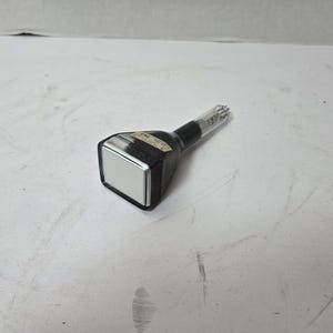 May include: A vintage cathode ray tube (CRT) with a black body and a clear glass neck. The CRT has a rectangular screen and a label on the side. The device is likely from an older television or computer monitor.