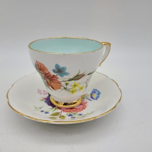 Sutherland china Tea cup and saucer blue inside w/ colorful floral pattern