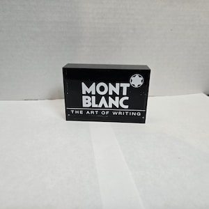 Pluma Montblanc The art of writing rara, pisapapeles de metacrilato, placa publicitaria