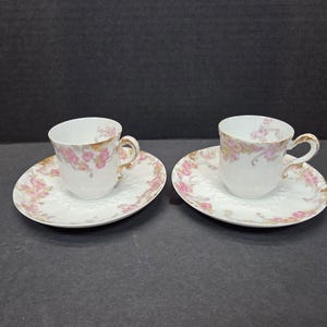 Pair of ornate CFH/GDM Limoges Demitasse Tea cups and saucers Pink flowers