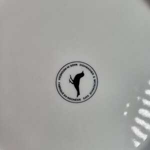 May include: White ceramic plate with a black bird logo that says "Made in Indonesia, Dishwasher & Microwave Safe"
