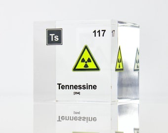 May include: A clear acrylic cube with the chemical symbol "Ts" and the atomic number "117" printed on it. The cube also has the word "Tennessine" printed on it, along with a yellow and black radiation warning symbol.