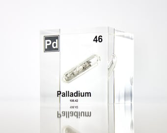 May include: A clear acrylic cube with a sample of palladium metal inside. The cube has the chemical symbol "Pd", atomic number "46", and the word "Palladium" printed on it.