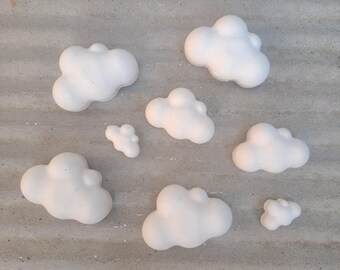 Puede incluir: Un conjunto de siete decoraciones blancas en forma de nube. Las nubes están hechas de un material suave y ligero, perfectas para añadir un toque de fantasía a cualquier habitación.