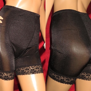 May include: Black sheer shorts with a lace trim. The shorts are made of a shiny, silky material.