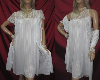 May include: White lace-trimmed nightgown with a satin-like finish and a matching robe. The nightgown has a V-neckline and a pleated skirt. The robe has a shawl collar and is open in the front.