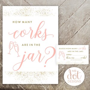 May include: A white printable sign with gold glitter accents that says "How many corks are in the jar?" with a pink silhouette of two champagne glasses. A smaller white card with gold glitter accents says "Guess how many corks are in the jar!" with a pink silhouette of two champagne glasses. The card has a space for a name and a line for the number of corks. The card also says "May the closest guesser win!" and has a logo that says "MB dot DESIGNS".