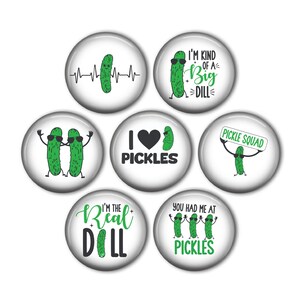 May include: Set of six round white button pins with green pickle illustrations and pickle-themed text. The pins feature phrases like "I'm kind of a big dill", "I love pickles", "Pickle Squad", "You had me at pickles", "I'm the real dill", and "Pickles" with a heart.