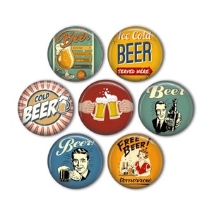 May include: A collection of seven round beer-themed buttons with vintage designs. The buttons feature illustrations of beer glasses, bottles, and retro advertisements with phrases like "Ice Cold Beer" and "Free Beer Tomorrow."