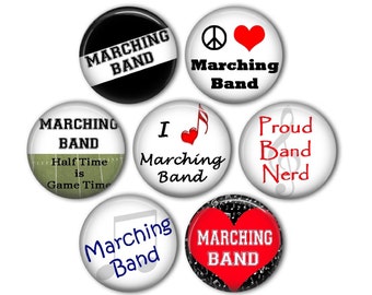 May include: Set of 7 round buttons with various designs featuring the words "Marching Band" and musical notes. Some buttons have a red heart, a peace sign, and a football pitch.