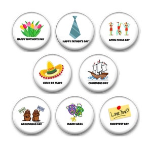 May include: Nine white round buttons with different holiday themes. The buttons feature images of flowers, a tie, clowns, a sombrero, a ship, two groundhogs, Mardi Gras masks, and a heart with the words "Love You".