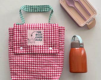 Una pratica borsa porta pranzo a quadretti per donna, pensata per l'uso quotidiano.