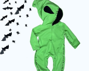 May include: Green hooded jumpsuit with black stitching and a black face mask. The jumpsuit is designed to look like a monster or creature.