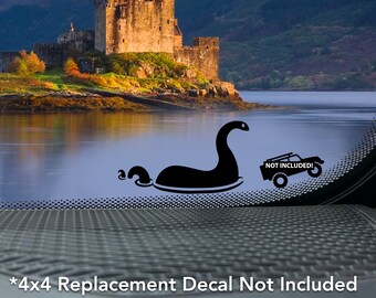 May include: A black and white decal of a Loch Ness Monster with a 4x4 truck decal in the background. The text "NOT INCLUDED!" is on the truck decal. The text "*4x4 Replacement Decal Not Included Sold Separately" is at the bottom of the image.