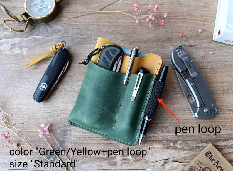 May include: A green leather wallet with a yellow interior and a pen loop. The wallet has two slots for carrying pens or other small items. The text "color "Green/Yellow+pen loop" and "size "Standard" is visible below the wallet.