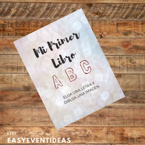 Könnte beinhalten: Ein weißer und grauer Hintergrund mit einem unscharfen Bokeh-Effekt. Der Text "Mi Primer Libro ABC" ist in Schwarz geschrieben. Die Buchstaben A, B und C sind in Rot geschrieben. Der Text "Elija una letra y dibuja una imagen" ist in Schwarz geschrieben.