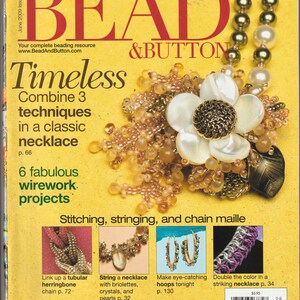 May include: A magazine cover with the title "BEAD & BUTTON" and the headline "Timeless" featuring a necklace with a flower design. The cover also showcases various jewelry projects and techniques.