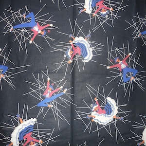 May include: A black fabric with a repeating pattern of dancers in red, blue, and white. The dancers are in a starburst pattern with white lines radiating from them.