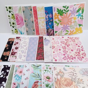 May include: A collection of rectangular paper cards featuring various floral and botanical patterns in diverse color palettes including pink, blue, yellow, and green. The designs include illustrations of flowers, leaves, and birds, arranged in multiple rows and overlapping layers.