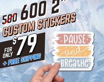 May include: A hand holding a custom sticker with the words "PAUSE and BREATHE" in a layered design. The image also shows text that reads "600 2" CUSTOM STICKERS". The sticker is laminated, waterproof, and dishwasher safe.