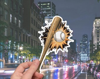 May include: A baseball-themed sticker featuring a baseball bat and ball with a burst effect. The bat is brown, and the ball is white with red stitching. The sticker is held in front of a city street at night.