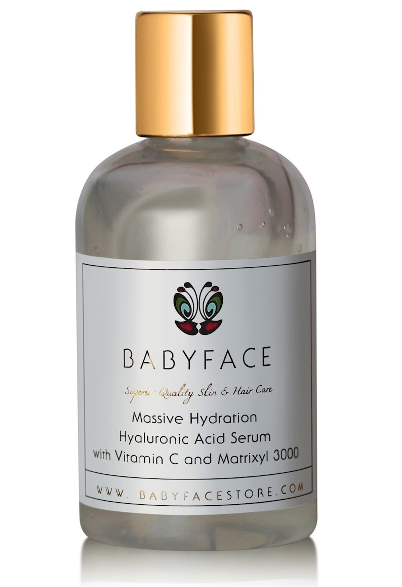 May include: A clear glass bottle with a gold lid and label. The label reads "BABYFACE Superior Quality Skin & Hair Care Massive Hydration Hyaluronic Acid Serum with Vitamin C and Matrixyl 3000 WWW.BABYFACESTORE.COM".