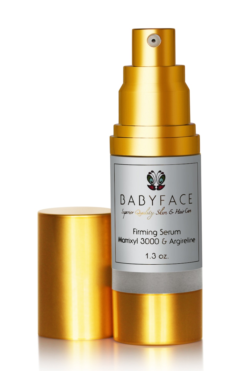 May include: A gold bottle with a pump dispenser containing a firming serum. The bottle is labeled "BABYFACE Superior Quality Skin & Hair Care Firming Serum Matrixyl 3000 & Argireline 1.3 oz."