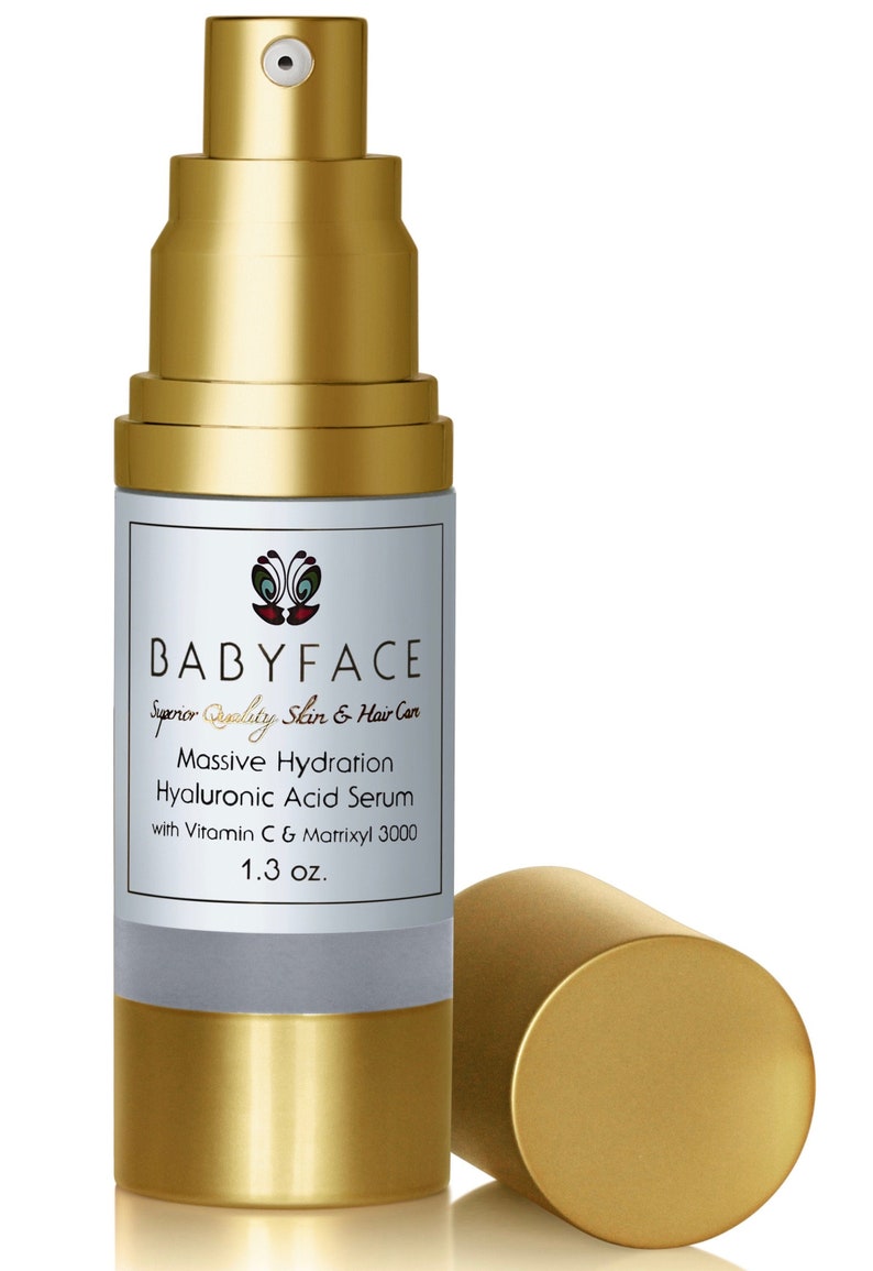 May include: A gold bottle with a pump dispenser containing Babyface Massive Hydration Hyaluronic Acid Serum with Vitamin C & Matrixyl 3000. The bottle is 1.3 oz.