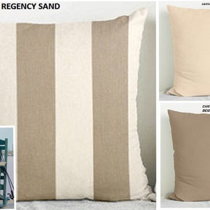 May include: A set of three throw pillows with different colors and patterns. The first pillow is a striped pattern with beige and white stripes. The second pillow is a solid beige color. The third pillow is a solid cream color. The pillows are all square shaped and have a simple design.