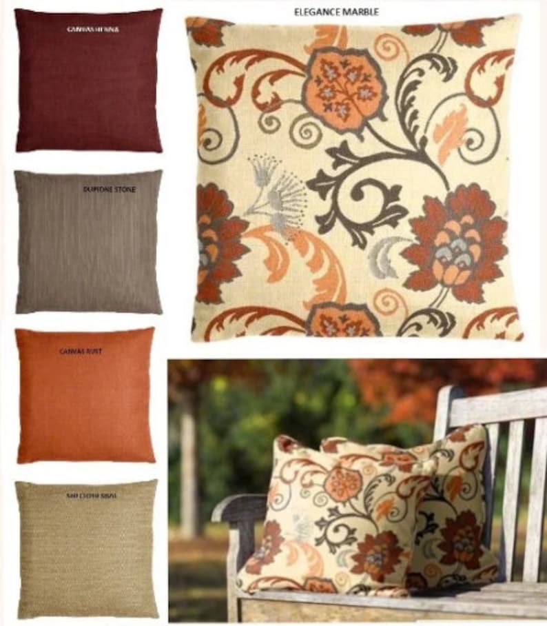 May include: Four decorative throw pillows with different textures and colors. The pillows are arranged in two rows of two. The top row features a burgundy pillow with the text "Canvas Herring" and a cream pillow with a floral pattern and the text "Elegance Marble". The bottom row features a brown pillow with the text "Dupione Stone" and an orange pillow with the text "Canvas Rust".