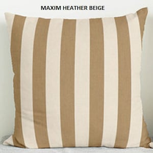 May include: A beige and white striped throw pillow with the text "MAXIM HEATHER BEIGE" printed on the top.