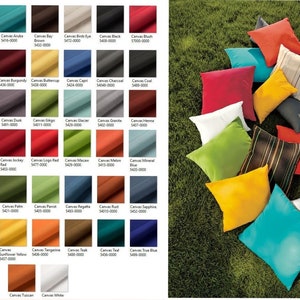 May include: A variety of fabric swatches in different colors and textures. The swatches are arranged in a grid pattern and labeled with their names and numbers. The swatches are displayed on a green grassy background.