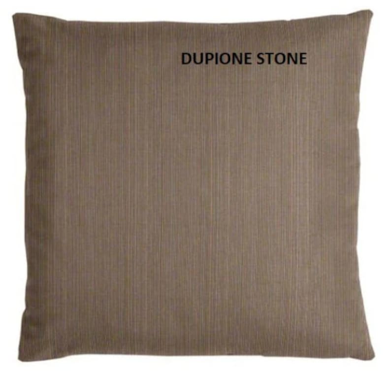 May include: A brown throw pillow with a textured fabric. The pillow has the text "DUPIONE STONE" printed on it.
