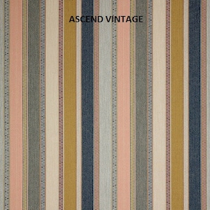 May include: A striped fabric with a variety of colors, including pink, blue, yellow, and white. The fabric has a textured weave and is labeled "ASCEND VINTAGE".