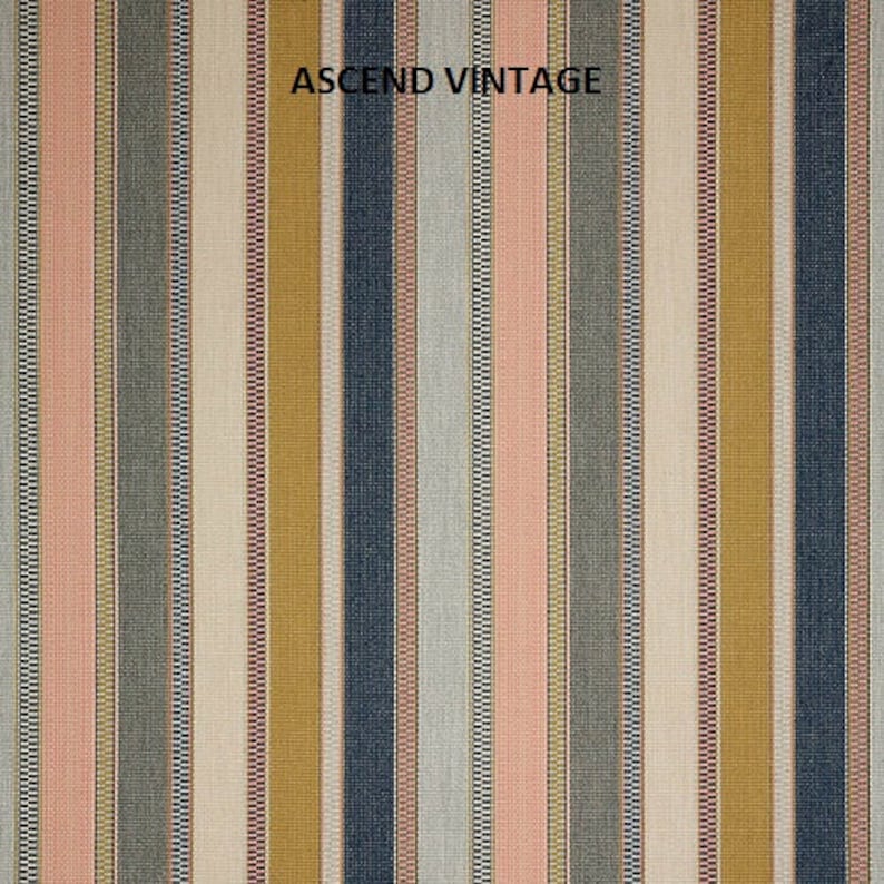 May include: A striped fabric with a variety of colors, including pink, blue, yellow, and white. The fabric has a textured weave and is labeled "ASCEND VINTAGE".