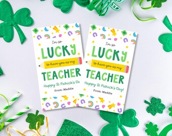 May include: Two printable cards with a St. Patrick's Day theme. The cards are white with green, yellow, and rainbow accents. The text on the cards reads "I'm so lucky to have you as my teacher. Happy St. Patrick's Day!" and "I'm so lucky to have you as my teacher. Happy St. Patrick's Day!" The cards are signed "From: Maddie".
