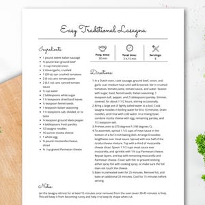 May include: A printed recipe for Easy Traditional Lasagna, with ingredients and instructions. The recipe includes Italian sausage, ground beef, and lasagna noodles. Garnishes of parsley, garlic, and a tomato half are visible.