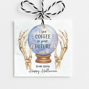 May include: Square gift tag with a watercolour design. A crystal ball with the text "I see COFFEE in your FUTURE" is held by skeletal hands. The tag also includes "Happy Halloween" and "from: Olivia".