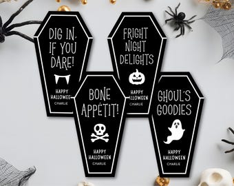 May include: Black coffin-shaped Halloween decorations with white text and illustrations. The phrases include "Dig In. If You Dare!", "Fright Night Delights", "Bone Appétit!", and "Ghoul's Goodies". Each design includes "Happy Halloween" and the name "Charlie".