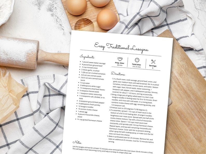 May include: A printed recipe for Easy Traditional Lasagna on a white sheet of paper. The recipe is on a wooden cutting board with eggs, a rolling pin, and a checkered cloth.