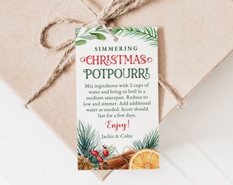 May include: A green and red gift tag with a white background. The tag has a festive Christmas design with a sprig of pine, cinnamon sticks, and a slice of orange. The text on the tag reads "Simmering Christmas Potpourri" and includes instructions for making the potpourri. The tag is tied with twine.