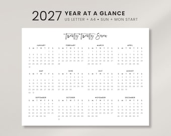 May include: A 2027 year at a glance calendar printed on white paper. The header reads 2027 YEAR AT A GLANCE US LETTER + A4 SUN + MON START. Below, the text Twenty Twenty Seven sits above twelve monthly grids with black text.