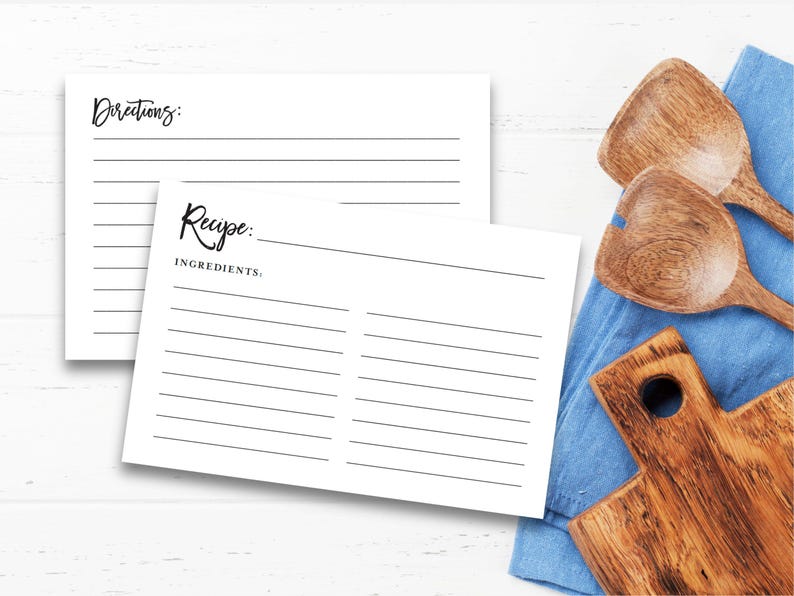 May include: Two blank recipe cards with lined spaces for writing down ingredients and directions. The cards are white with black lines and text.