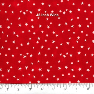 May include: Red fabric with a pattern of white stars. The fabric is 45 inches wide. The stars are scattered across the surface, creating a festive and playful design. The fabric is suitable for various crafting and sewing projects.