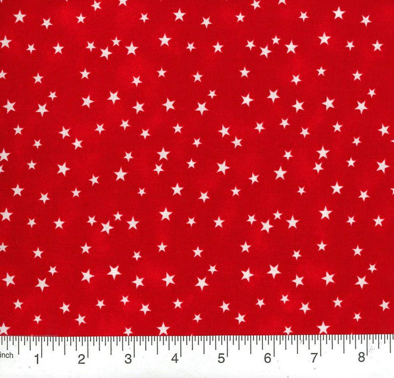 May include: Red fabric with a pattern of white stars of varying sizes. The stars are scattered across the fabric, creating a festive and playful design. The fabric is suitable for various craft projects and sewing.